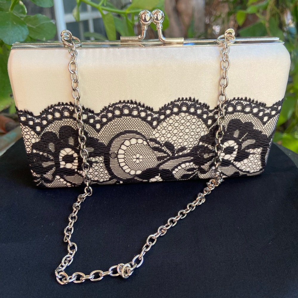 BCBGMAXAZRIA Elegant Kiss-lock Black and Cream Lace Clutch